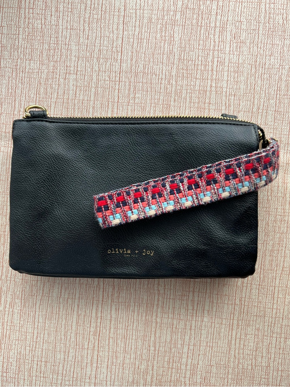 Olivia + Joy Black Wristlet with Red & Blue Woven Strap